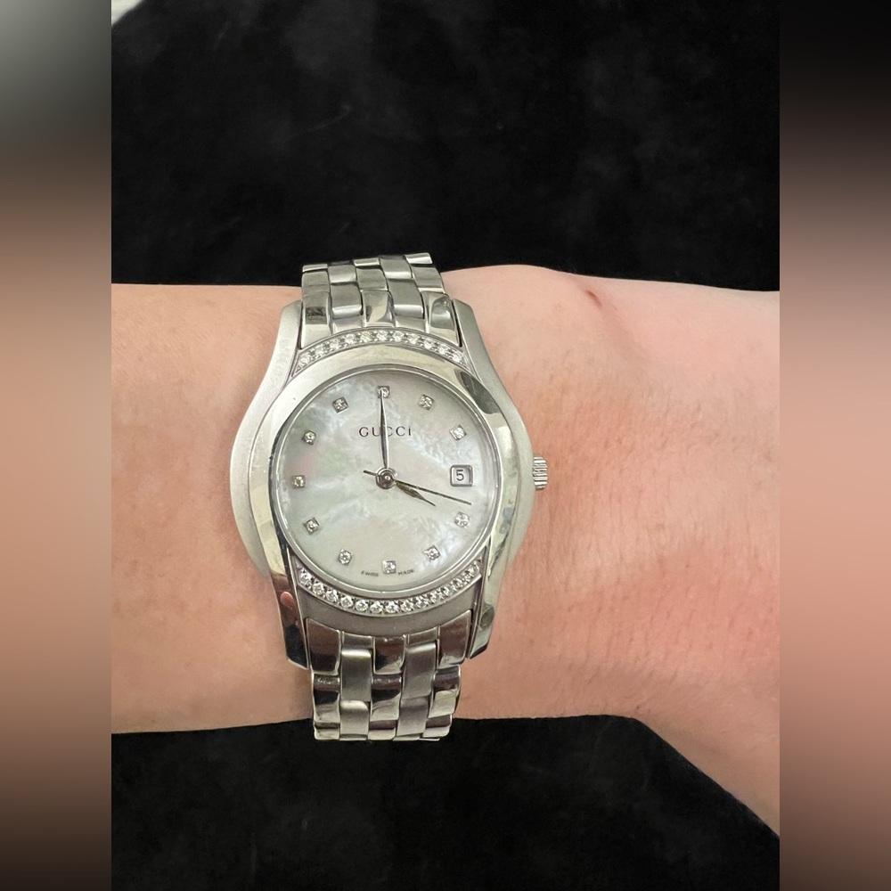 Women’s mother of pearl Gucci watch with diamonds
